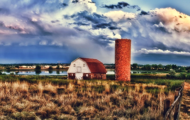 an old farm house and a grain silo