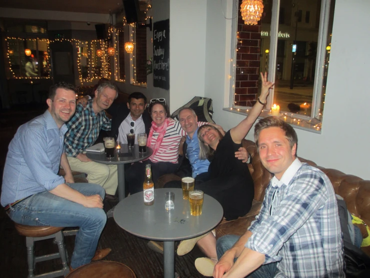 a group of friends poses for a po at a pub