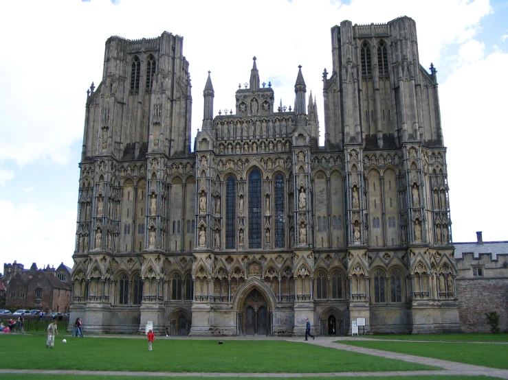 the side view of an old gothic cathedral on a cloudy day