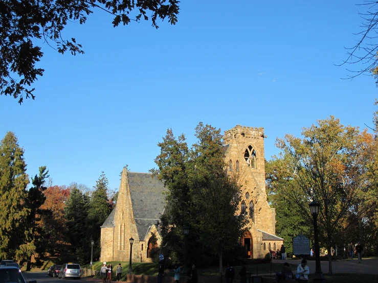 people gathered outside of an old church