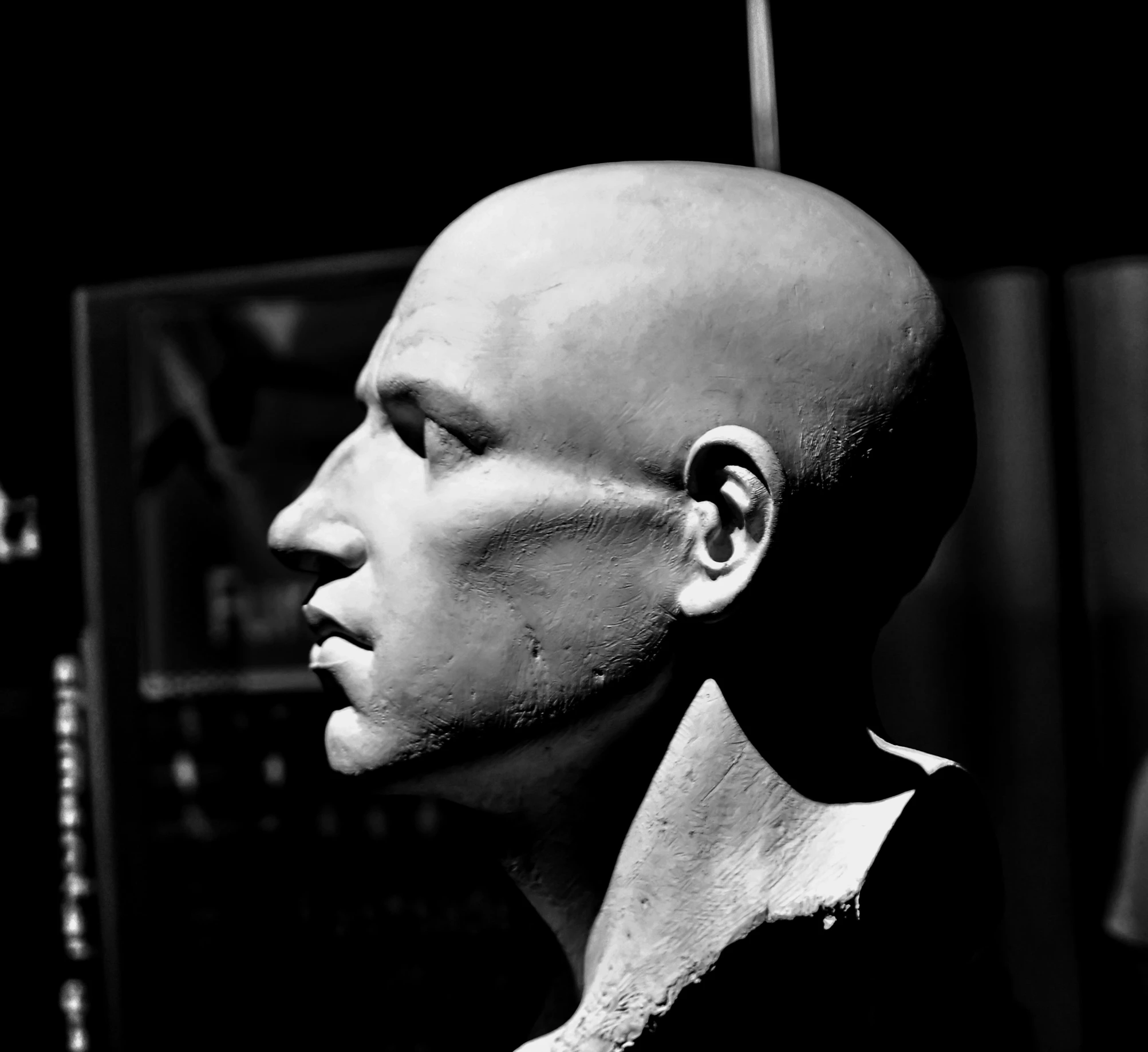 a man with bald head standing in front of a microphone