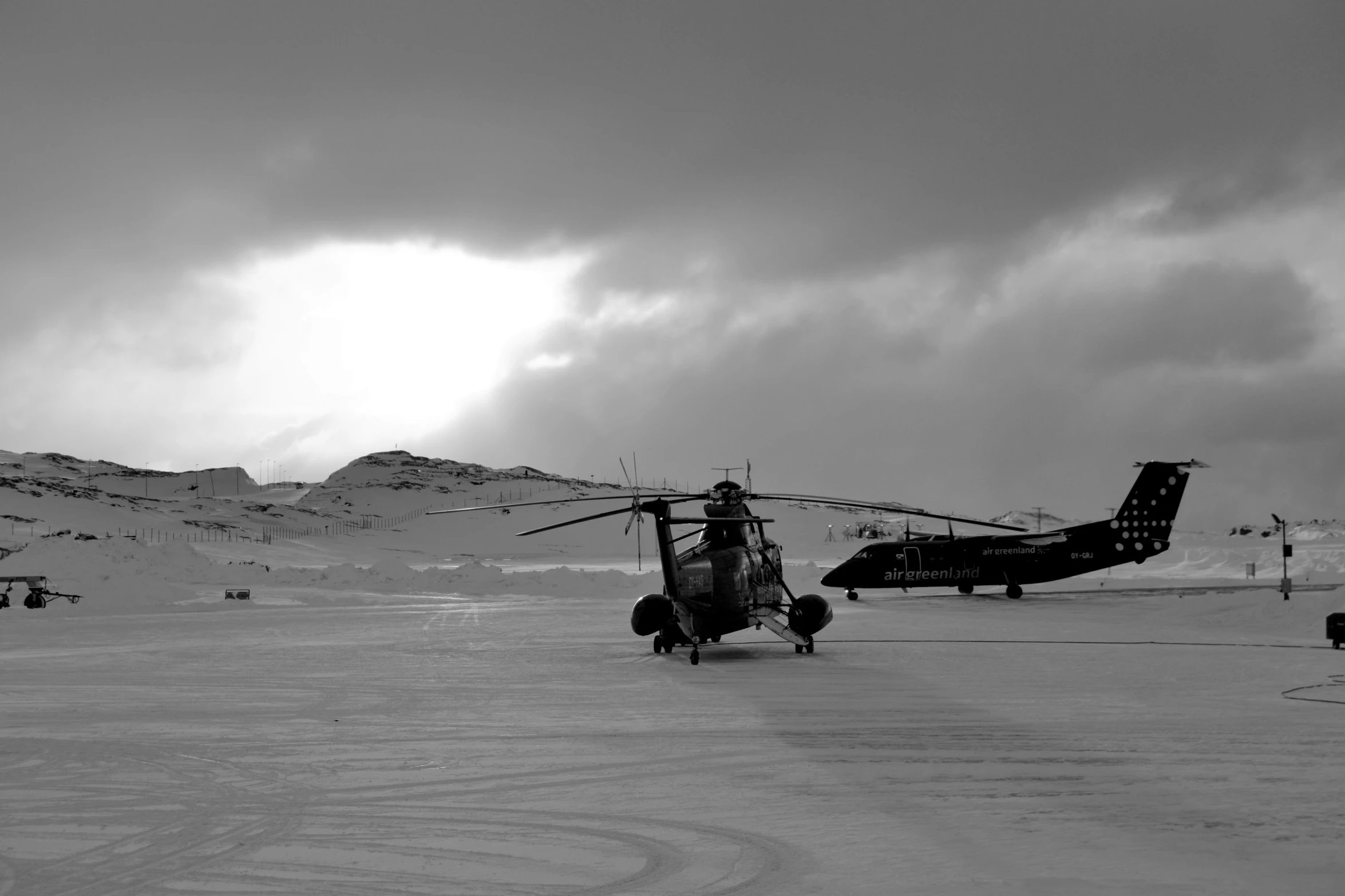 a black and white po of a helicopter parked in snow