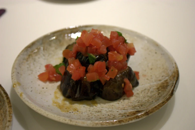 food on white plate with silverware and table cloth