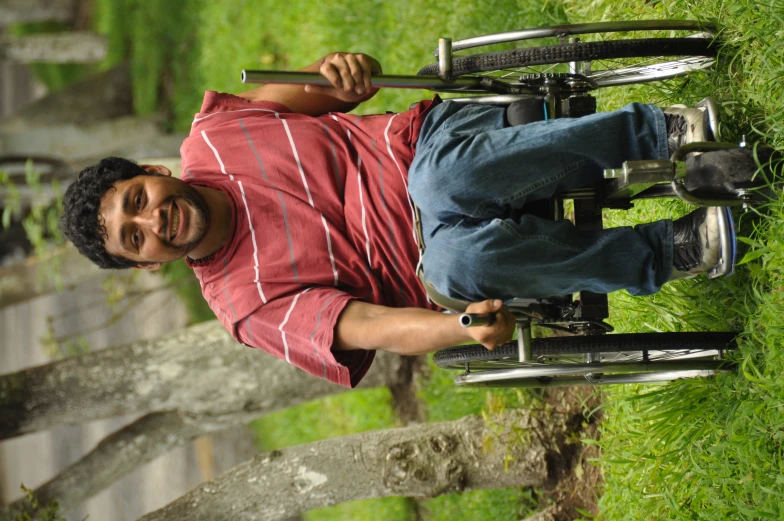 the smiling man in a wheel chair is holding a stick