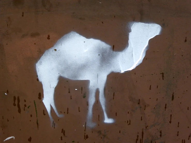 a white stencil of a camel on the brown surface