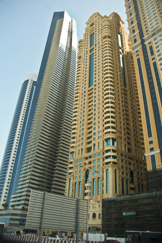 the view from the ground looking up at a large group of tall buildings