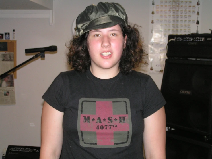 girl wearing a mash shirt and cap in a kitchen