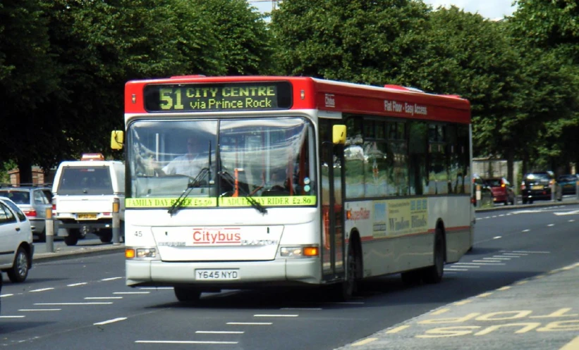 an image of a city bus going down the road