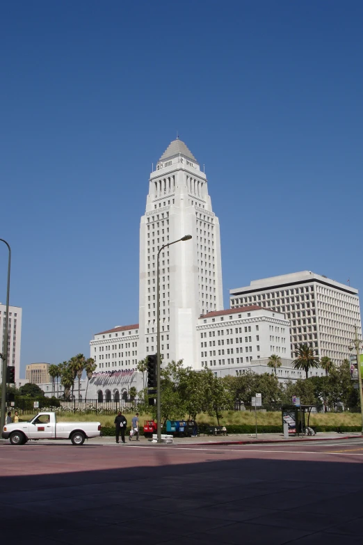 a white building with cars driving through the middle