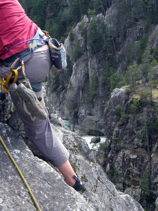 a hiker with a backpack reaches the edge of a cliff