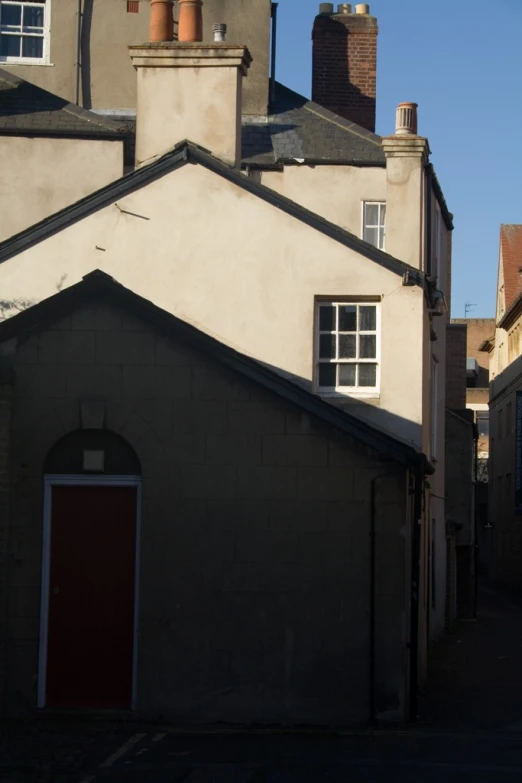 an old run down house with a red door