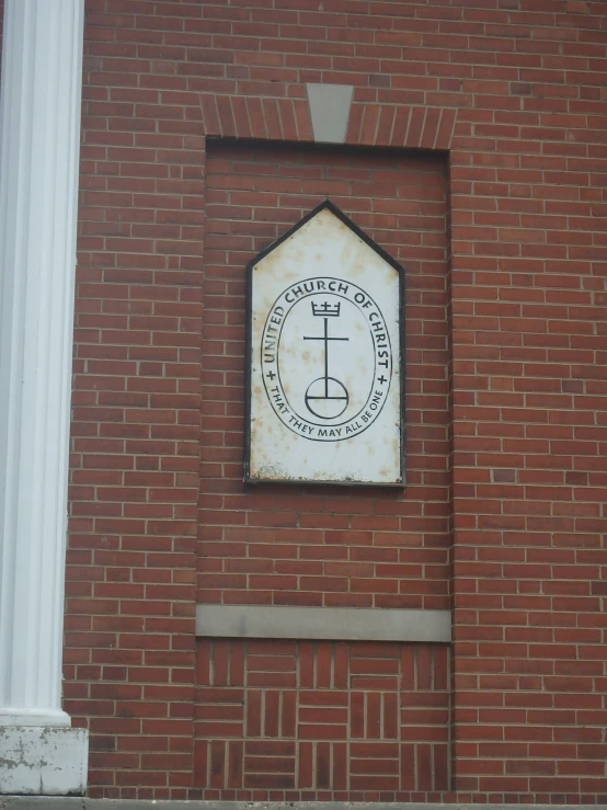 a brick building with an emblem mounted on it