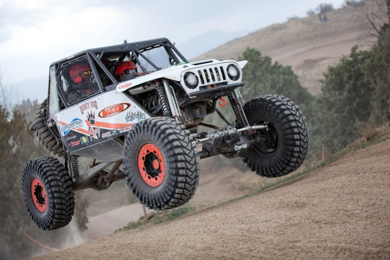 an off road buggy in mid air over sand