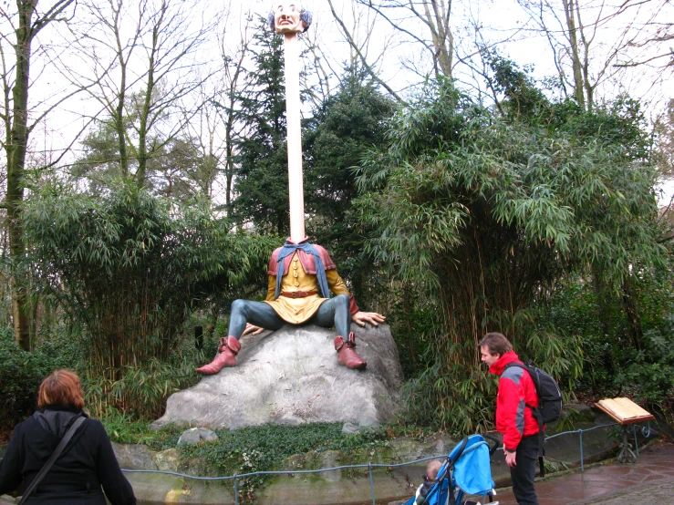 a group of people standing around a statue