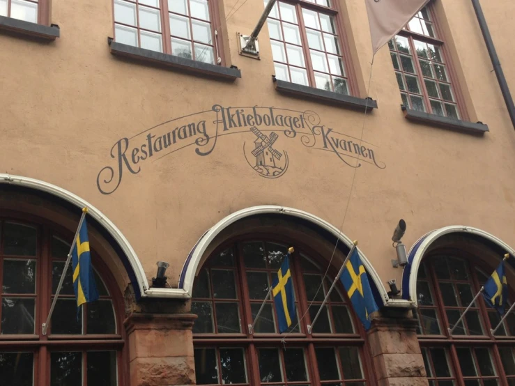 a building with three flags flying in front of it