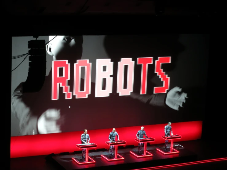 robot figurines sit on small red platforms