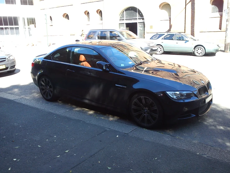 a black car is parked in a parking space