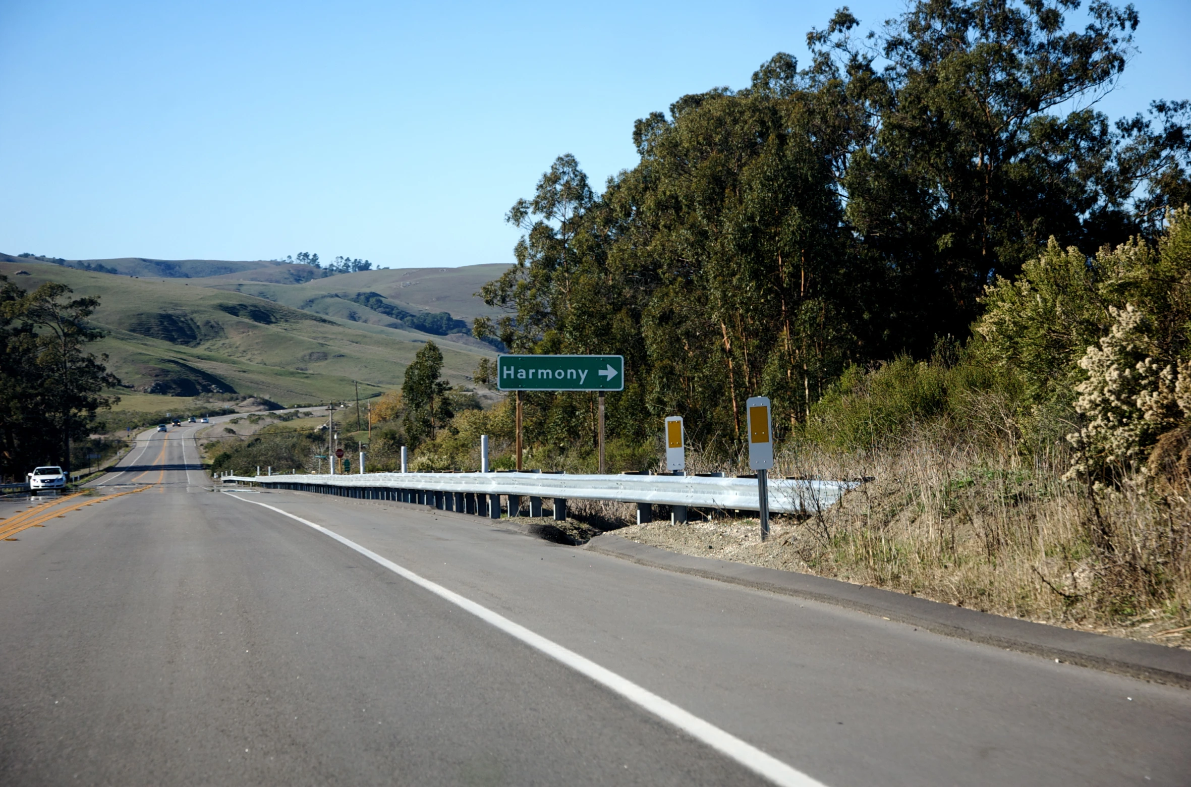 a highway that is close to a wooded hill