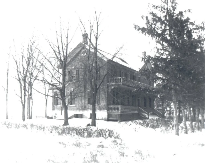 the house is very old and covered in snow