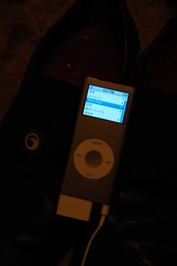 an ipod is being held up and placed on a table