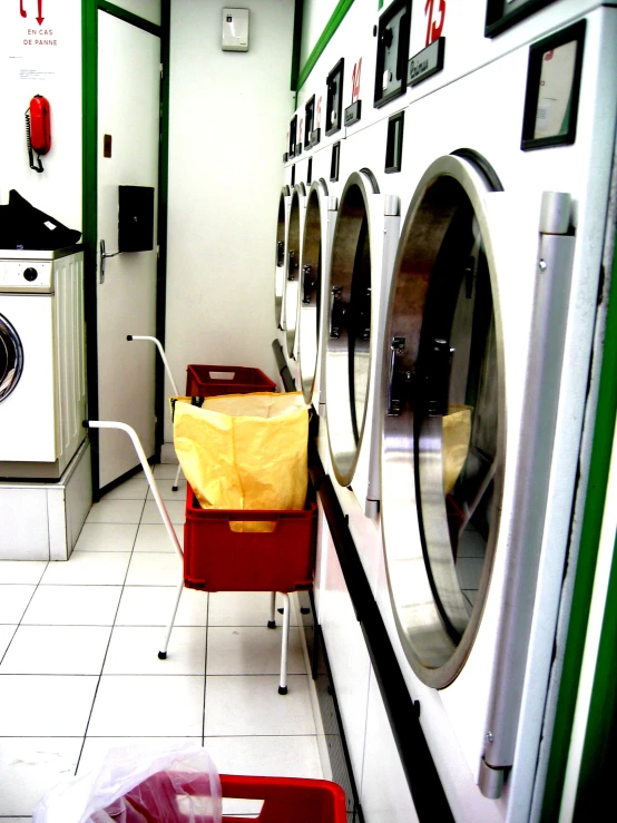 an industrial room with a washer and some laundry machines