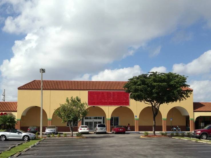 several cars are parked in front of a business