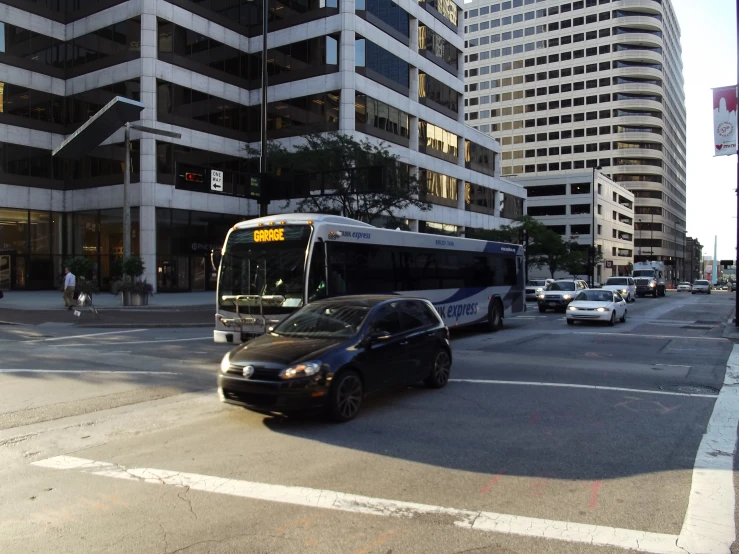 a bus in a city next to tall buildings