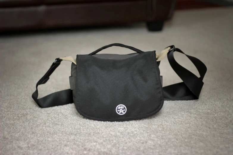 a black bag with a wooden handle sitting on the ground