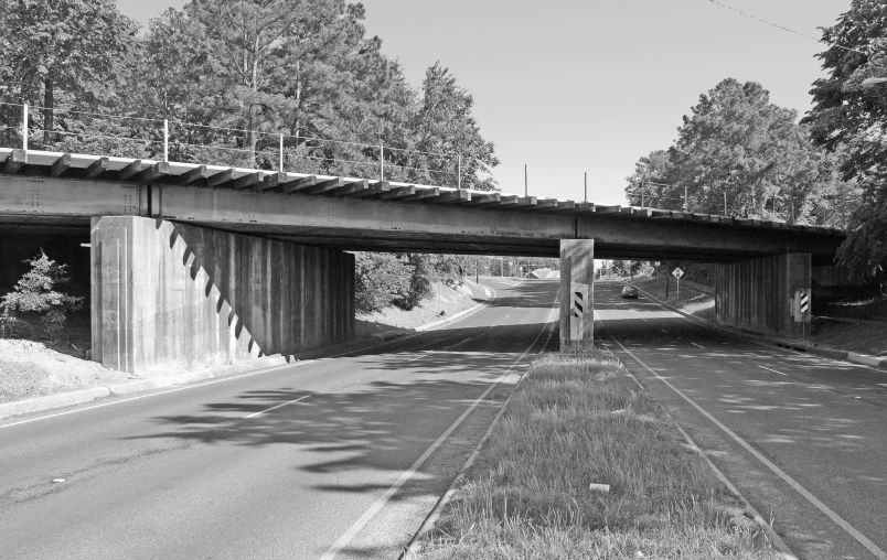 a large long bridge spanning over a long road