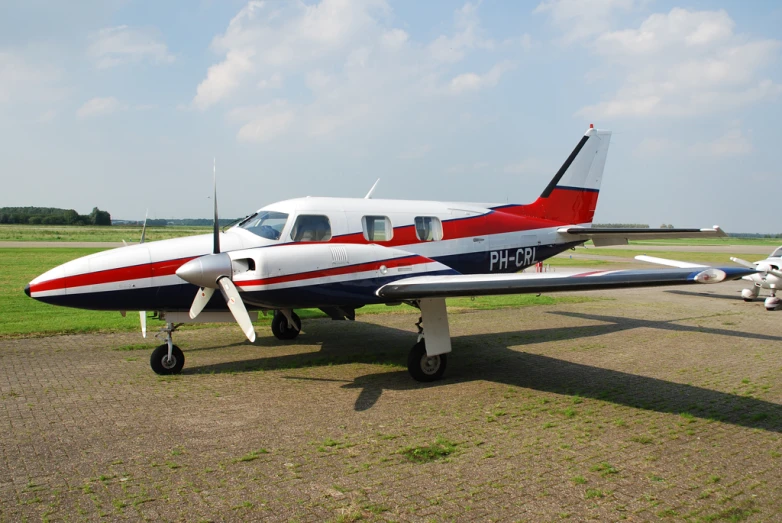 a small airplane with a man in the cockpit on the tarmac