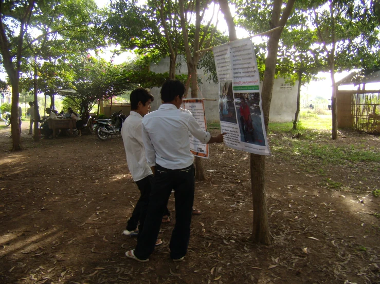 two men that are next to a poster