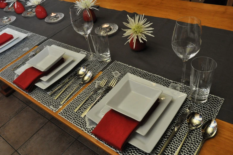 a long table set for four and ready for someone to sit down