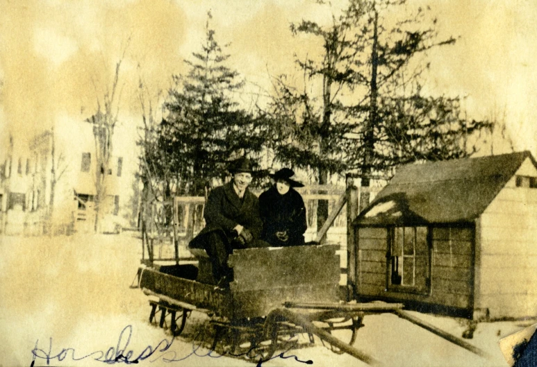 three men in a sleigh with an old time pograph