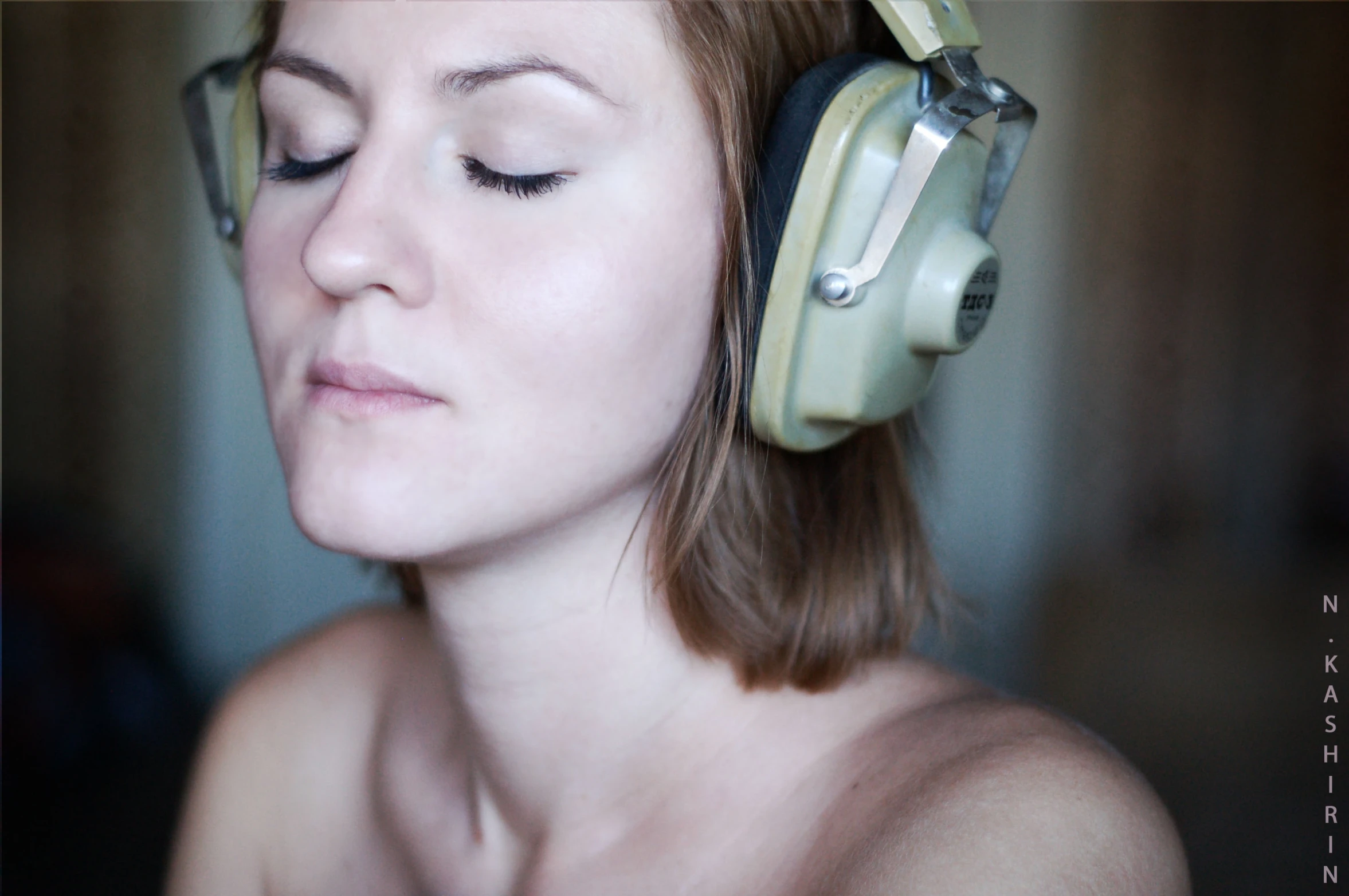 a woman with headphones on her head looking at soing