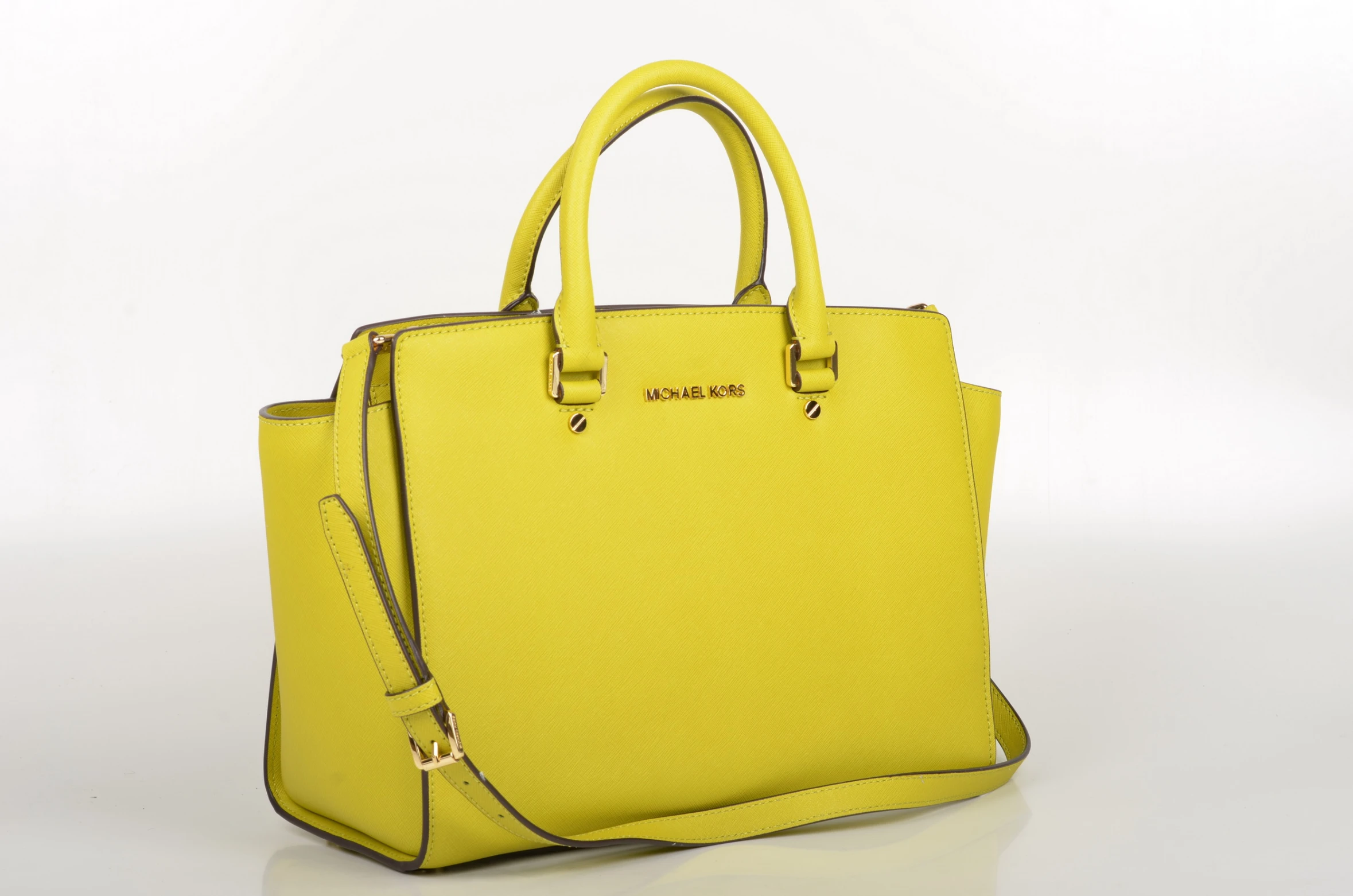 a yellow handbag is sitting on a white background