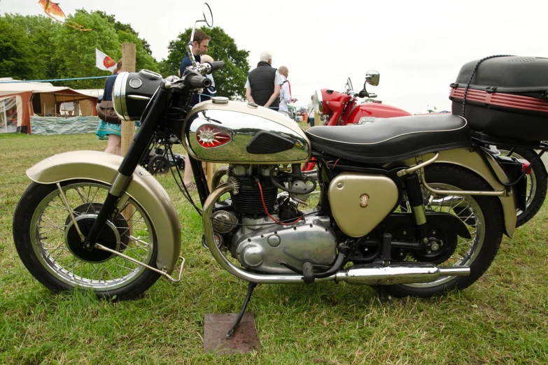 there is an old fashioned motorcycle on the grass