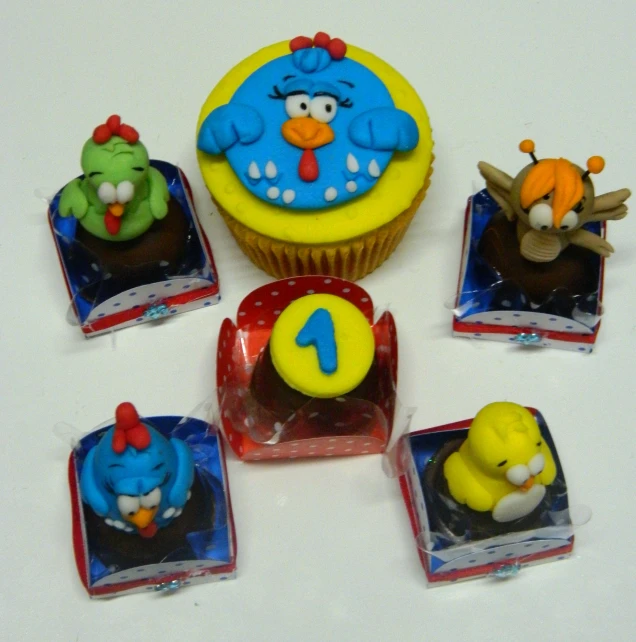 a cupcake with icing and angry birds characters on it