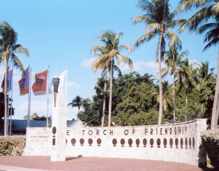 some palm trees and a sign that reads eichrchof friendship