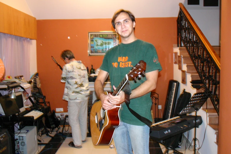 there is a man with an electric guitar in the living room