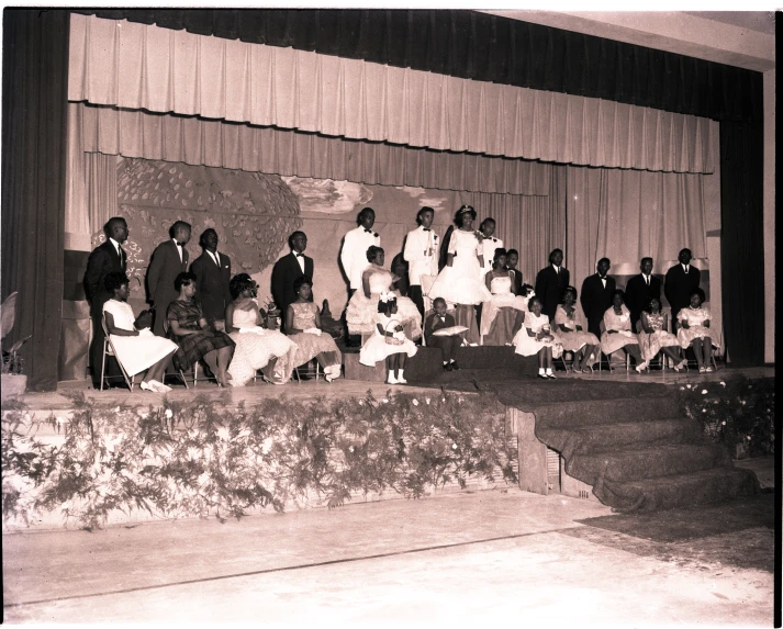 a group of people standing and sitting on steps