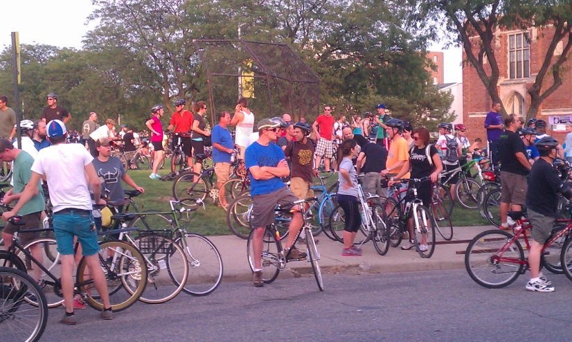 a crowd of bikers are gathered on the street