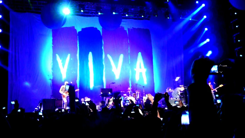 a concert stage with the name alive on the wall