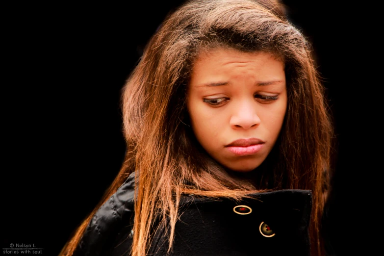 a close up of a young woman with long brown hair