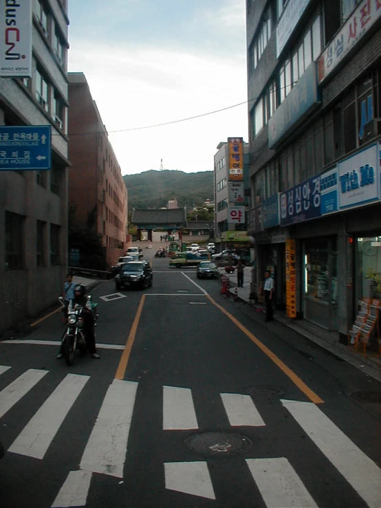 cars driving down the road next to a street