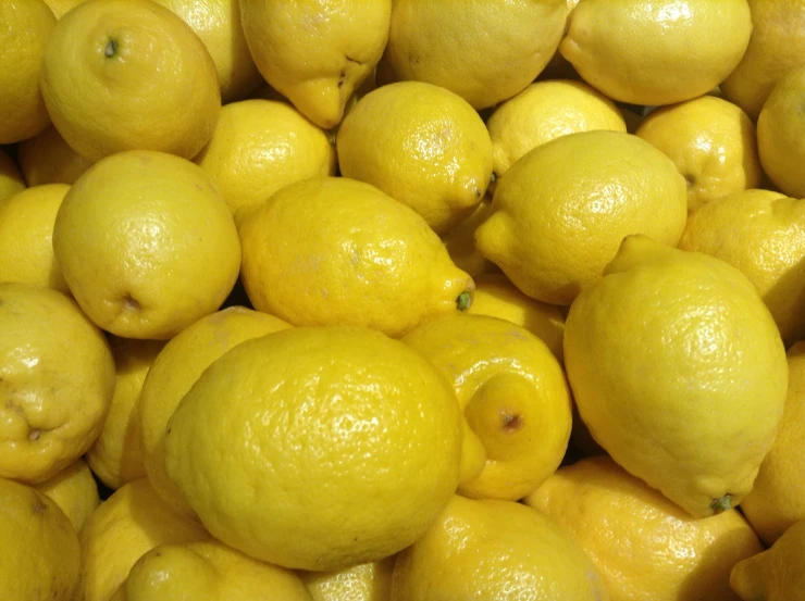 a large pile of lemons stacked together