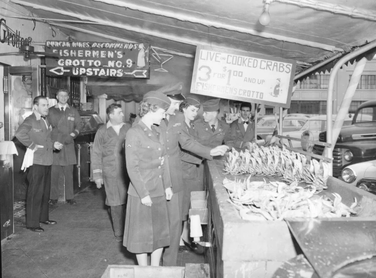 an old po of some men serving food