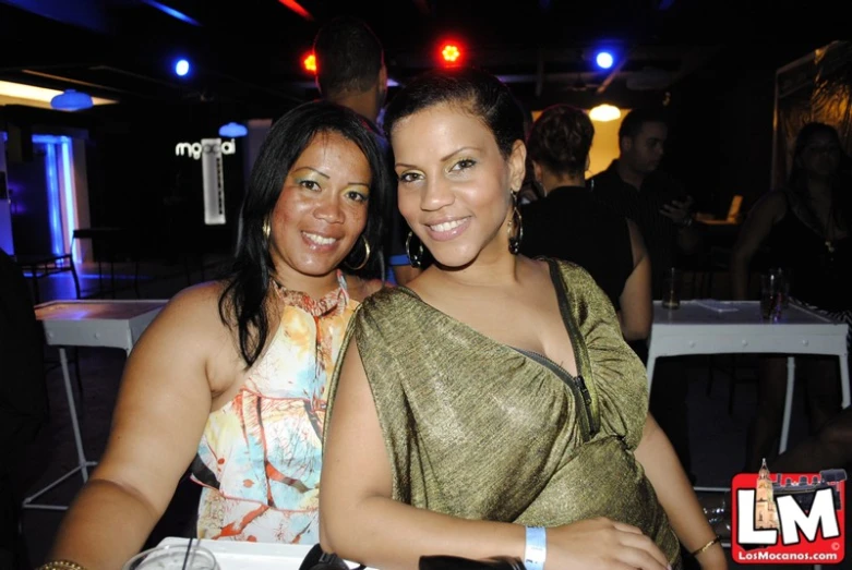 two women sitting together smiling at a party