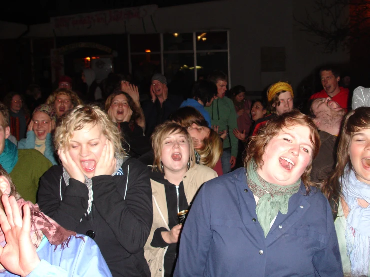 a group of people standing around each other