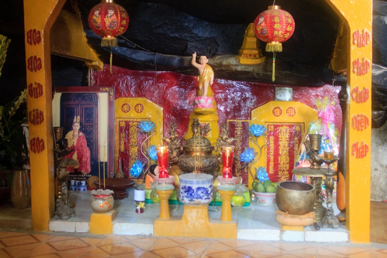 several asian decorations displayed in a chinese shrine