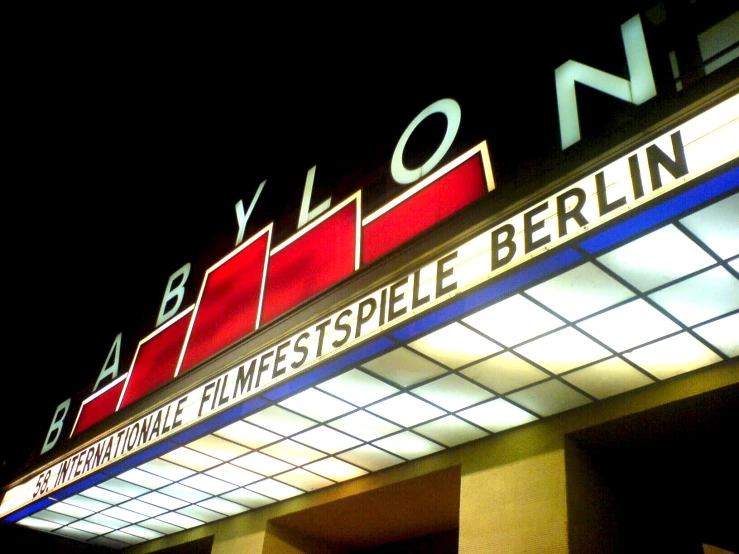 a large sign that says berlin on a dark night